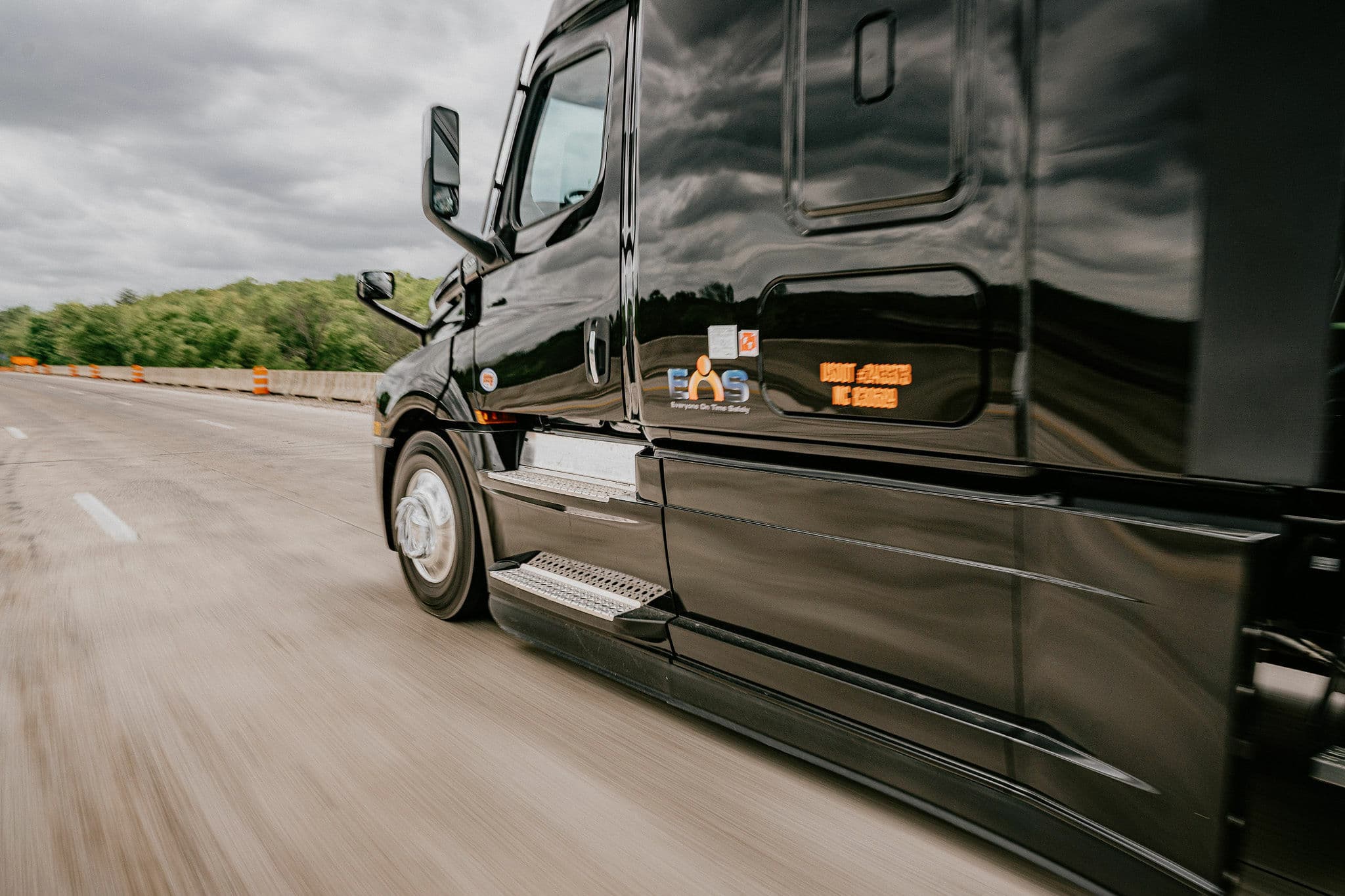 An EOS Trucking tractor-trailer rolling down the interstate